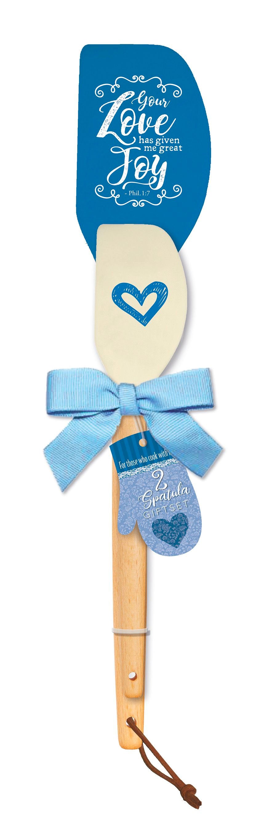 Our spatula giftset is for those who cook with love. Set includes 2 spatulas with silicon heads and solid wood handles. Large spatula measures 12" x 2.5" x 0.75". Small spatula measures 9.5" x 2" x 0.5". Features scripture. Material: Silicone / Wood.